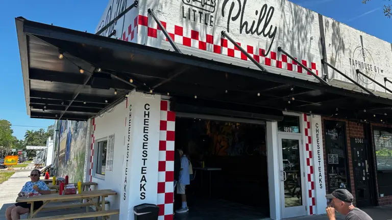 exterior of a restaurant with a red and white paint job on the front