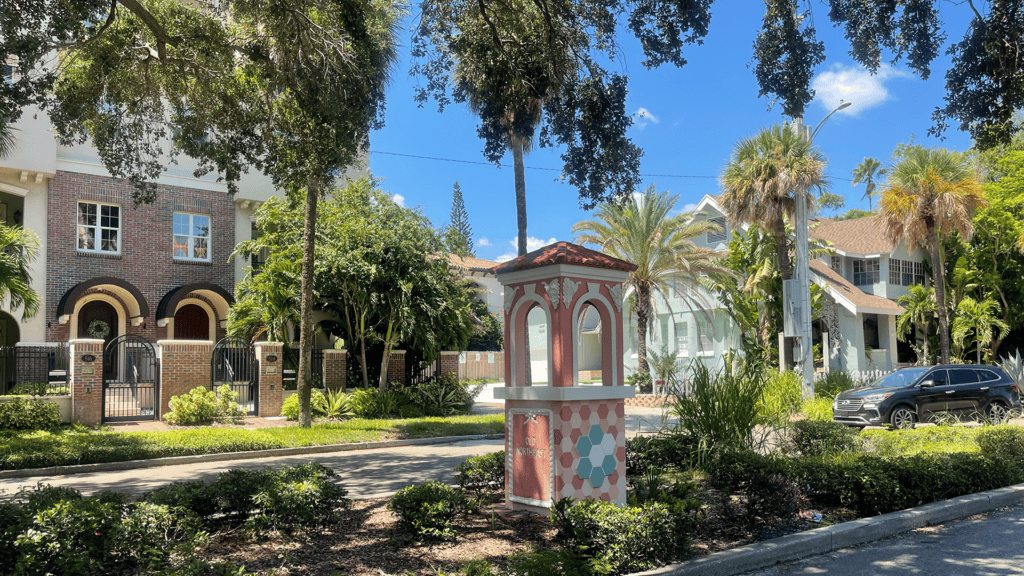 a pink column welcome sign in front of the old NE neighborhood
