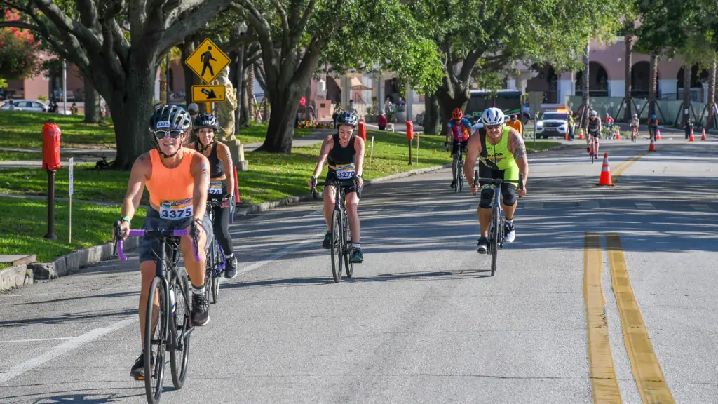 cyclists ride on the road around traffic cones during a scheduled triathlon 