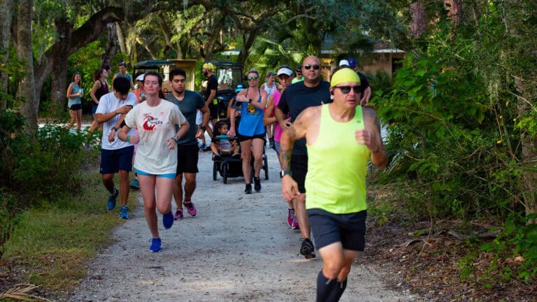 multiple people running on a trail