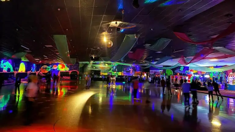 interior or a skating rink with people roaming on the floor