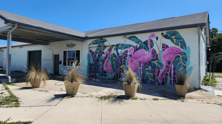 exterior of building with flamingo mural on wall