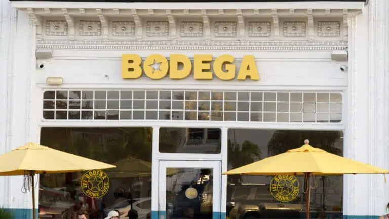 exterior of a restaurant with a large yellow sign over the front door