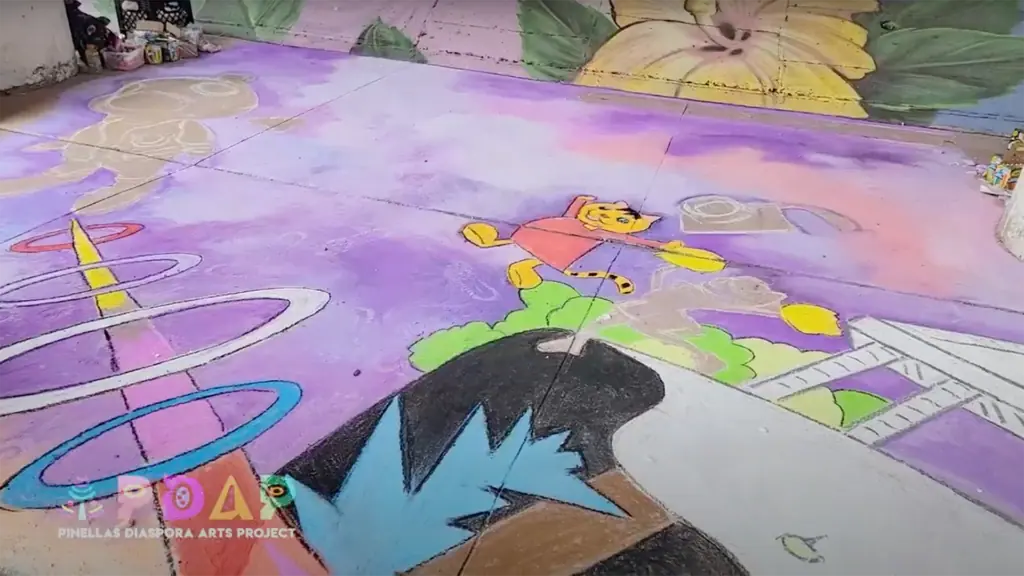 a large pink chalk mural with cartoon characters dancing on clouds