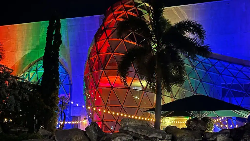 Rainbow lights on the outside of a museum's glass atrium