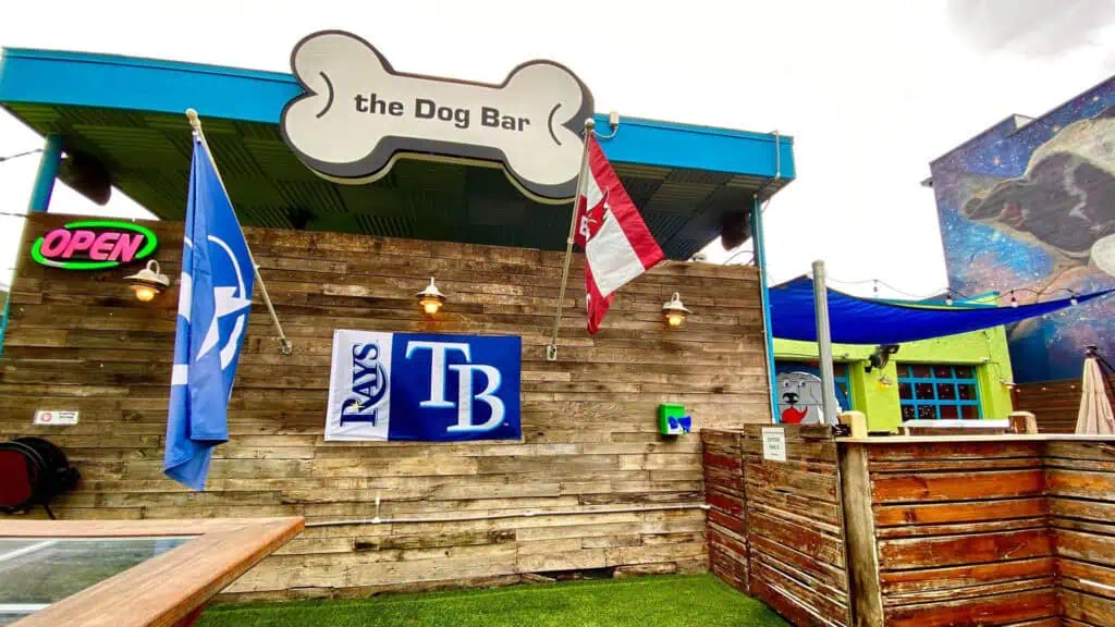 Exterior of a bar with a big sign in the shape of a bone