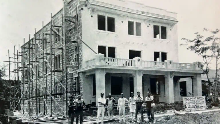 Historic 1923 photo of Hilcrest Hotel showing 8 men standing in front of hotel under construction