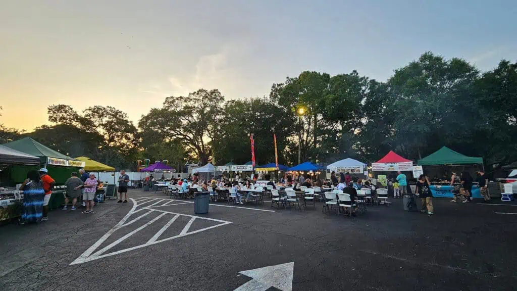 a group of vendors set up for a food and music event