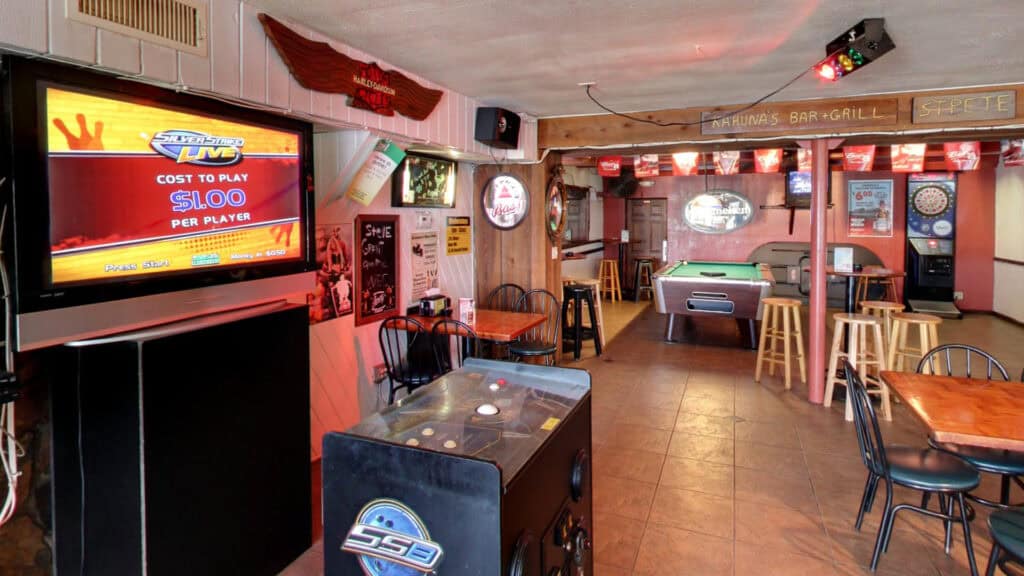 interior of a bar with pool tables and arcade games