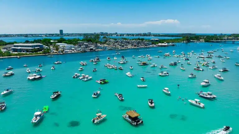 aerial view of clear blue waters filled with boaters enjoying a party