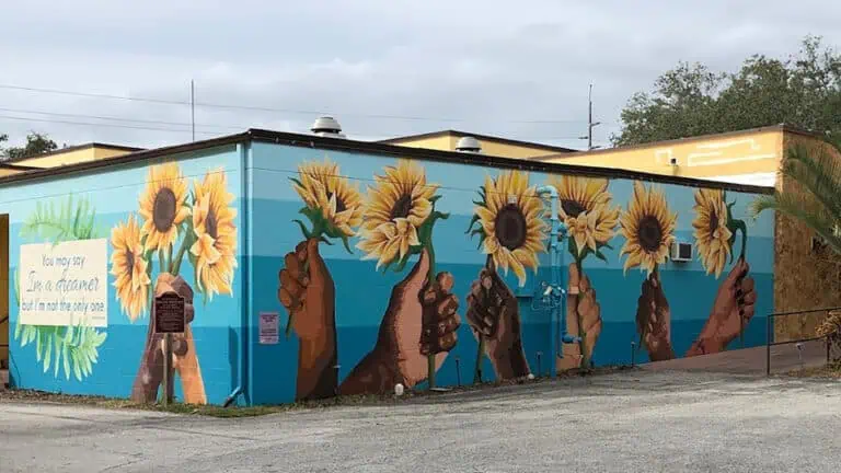 a flower mural on the side of a theatre
