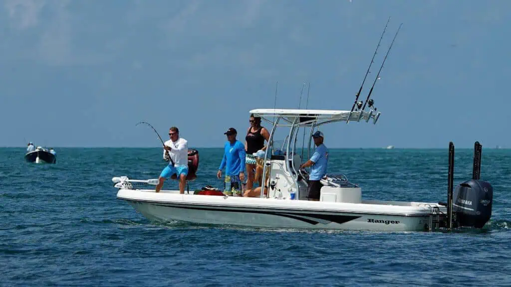 a man reels in a fish on a boat