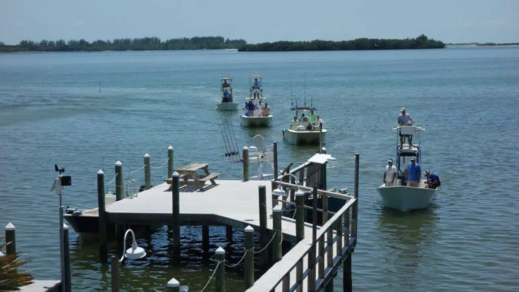 multiple boats approach a boat ramp