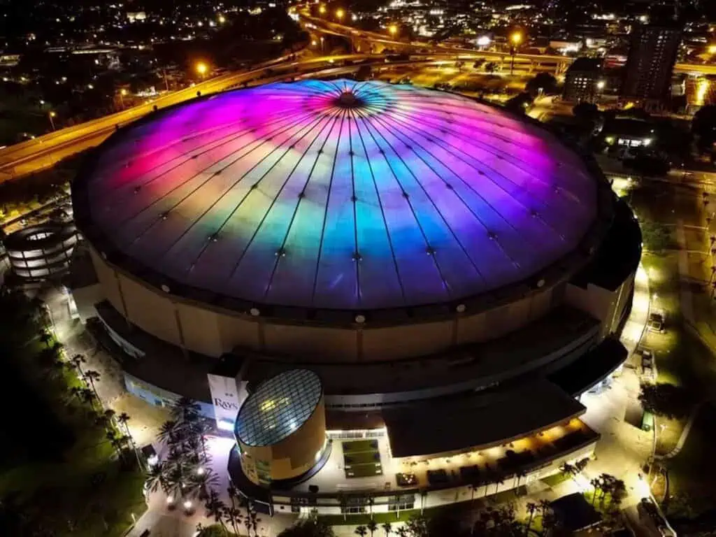 a large baseball stadium is lit up in rainbow colors for pride month