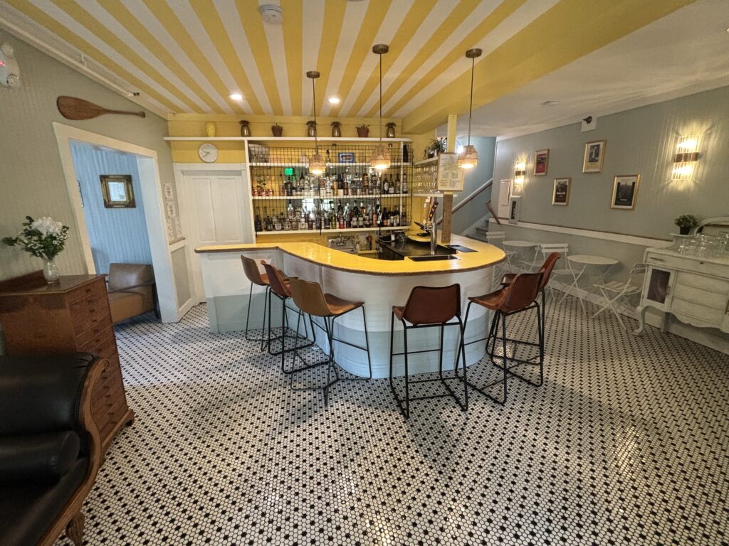 cocktail abr with yellow counter surrounded by stools.