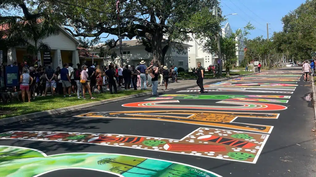 a large colorful. street mural in a downtown area