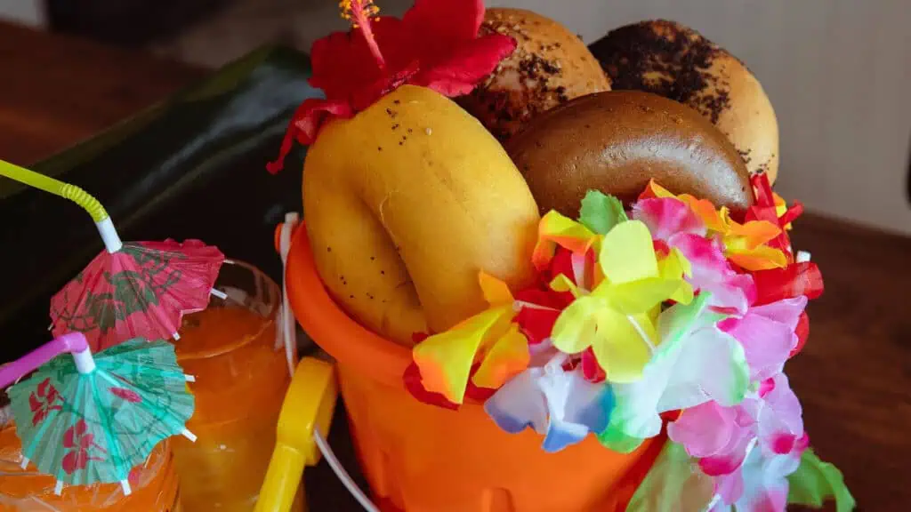 an orange bucket filled with bagels