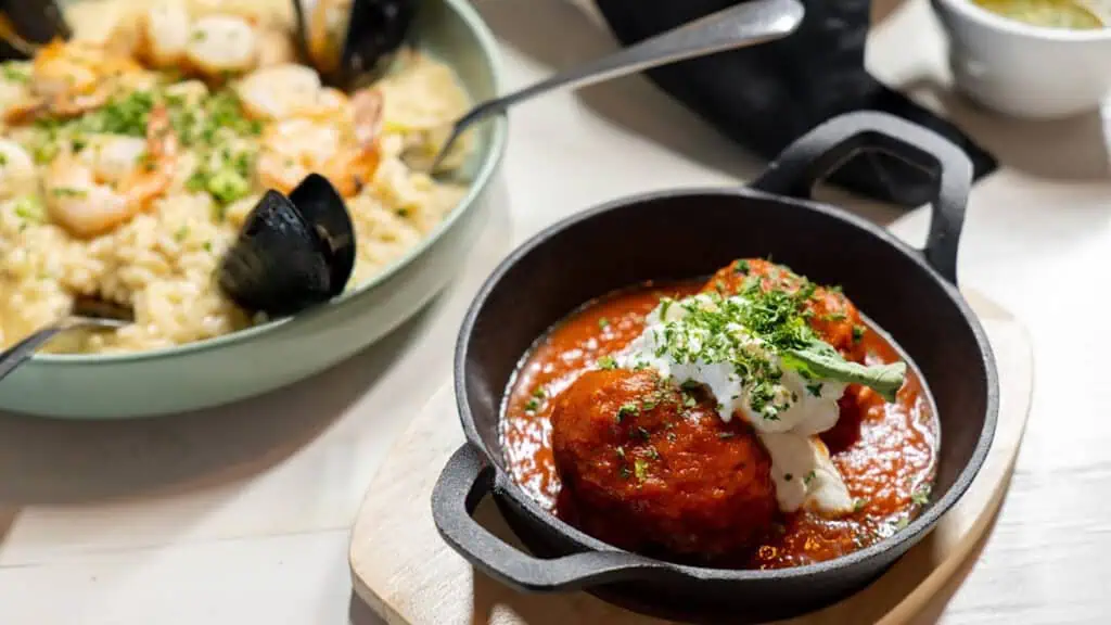 a plate of food including arancini and mussels