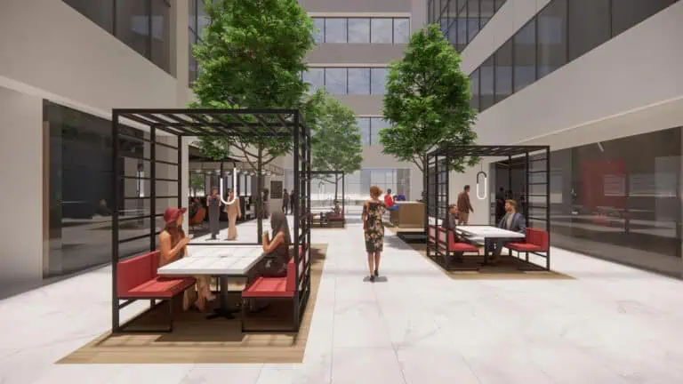 Rendering of lobby with people in seating areas and tables and indoor trees in an atrium style lobby