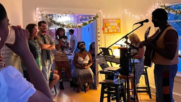 a group of people watch a live performance in a room