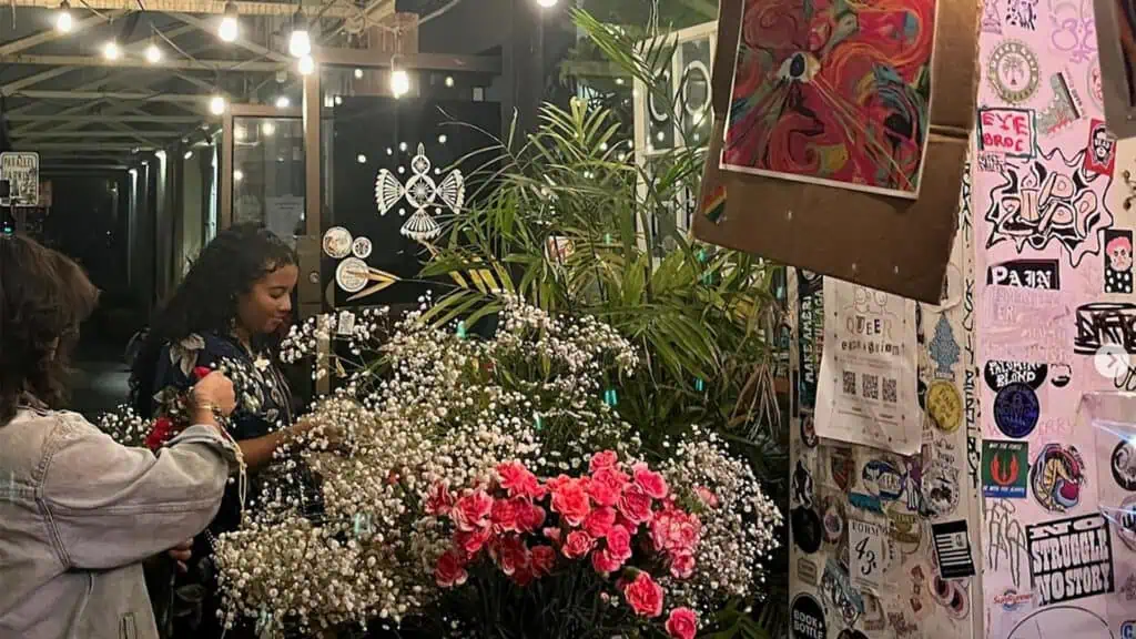 a large flower booth outside a cafe at night