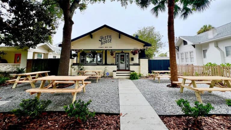 Exterior of a wine bar with picnic tables outside