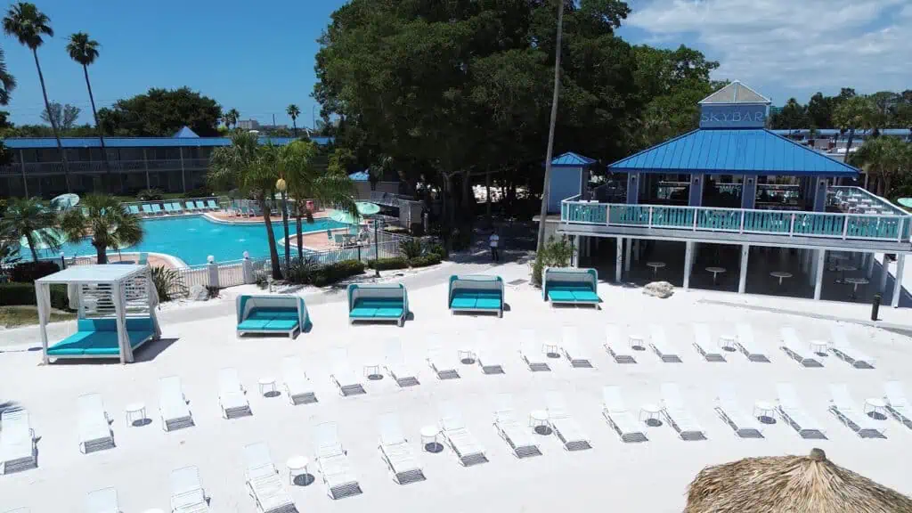 aerial view of a waterfront hotel with its own beach