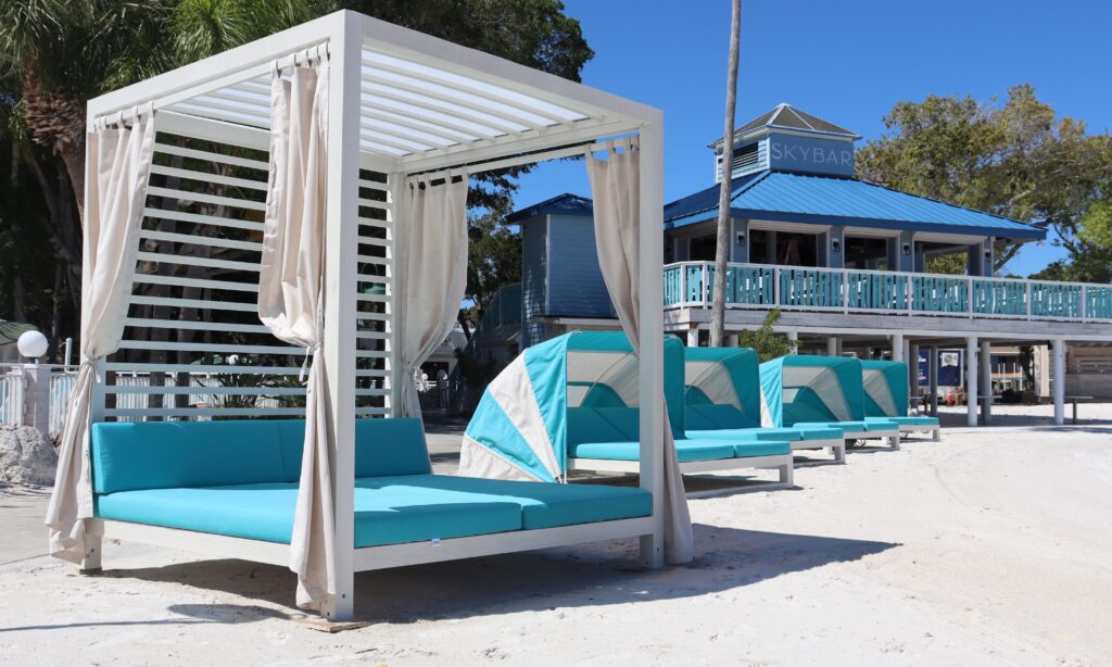 blue and white cabana with two story bar behind.