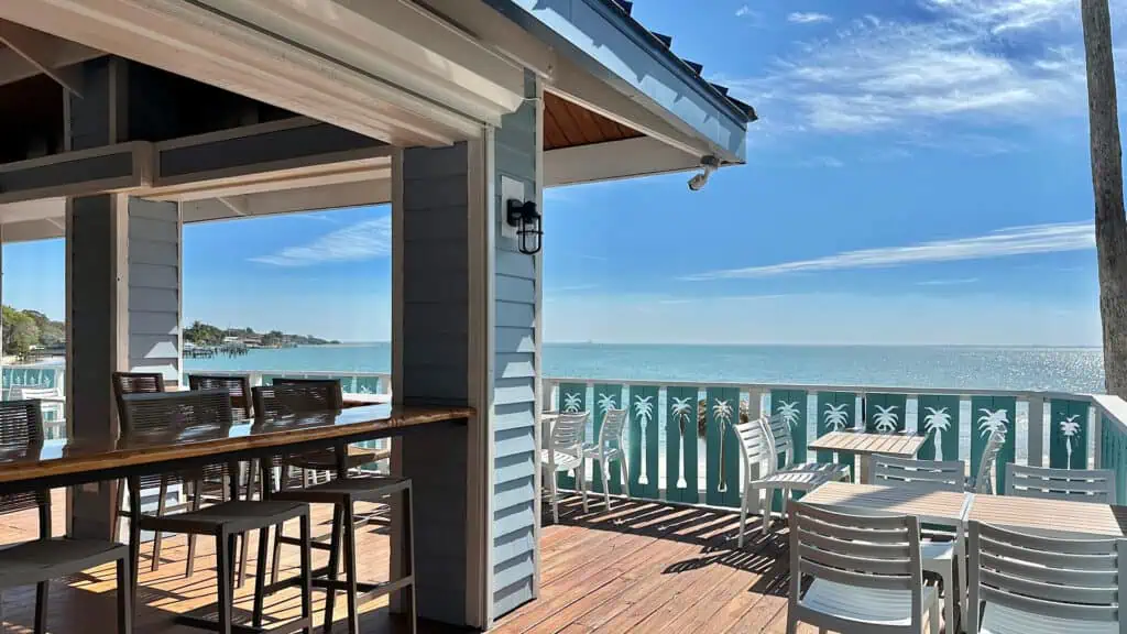 a rooftop restaurant and bar with a beach view