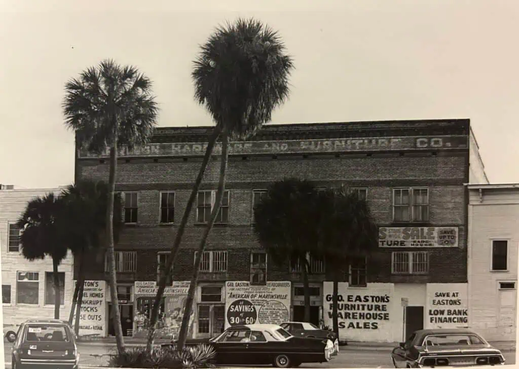 Black and white photo of an old brick hardware store in St. Petersburg