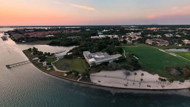 aerial photo of a waterfront college campus with a beach