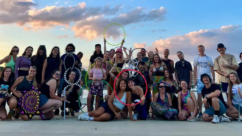 people on pier with hula hoops