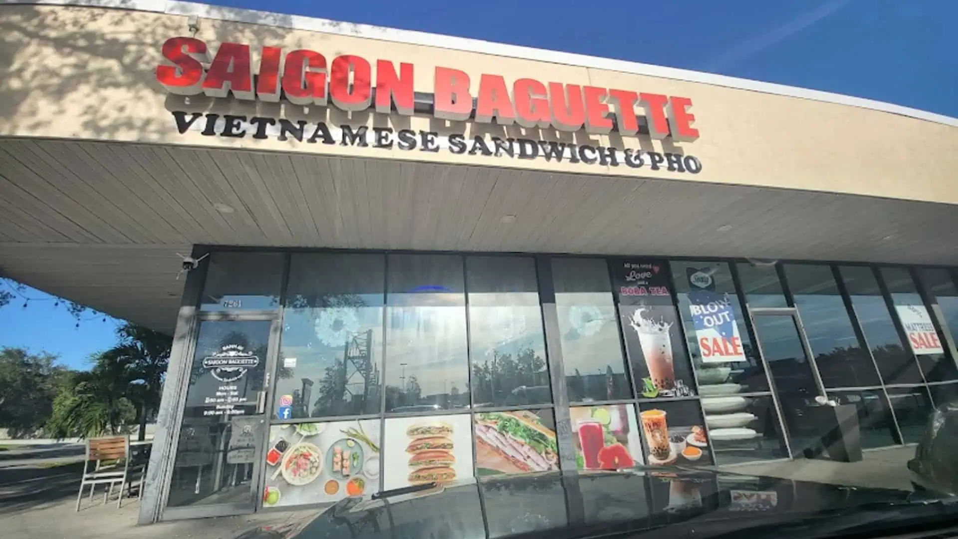 exterior of a strip plaza with a Bahn Mi restaurant on the corner