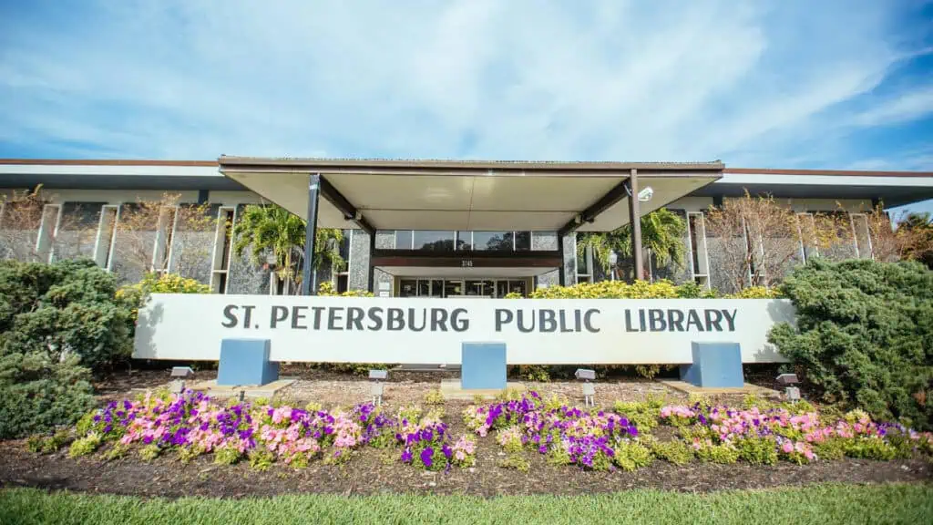 exterior of a library with flowers out front