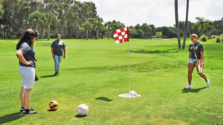 people play foot golf on a field