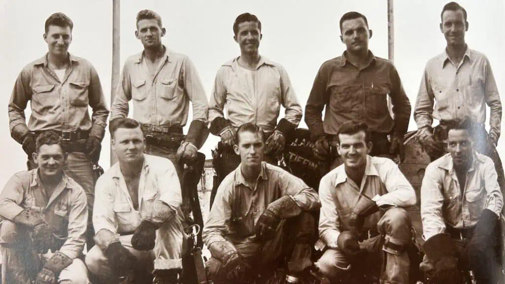 Black and white photo of linemen in the 1950s.