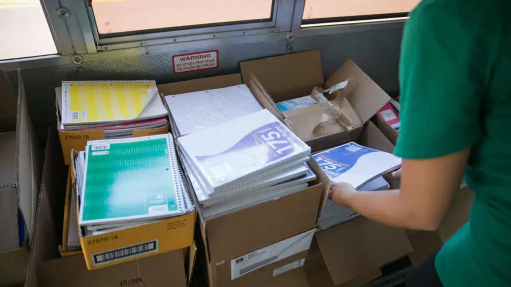 school supplies organized in boxes on a bus