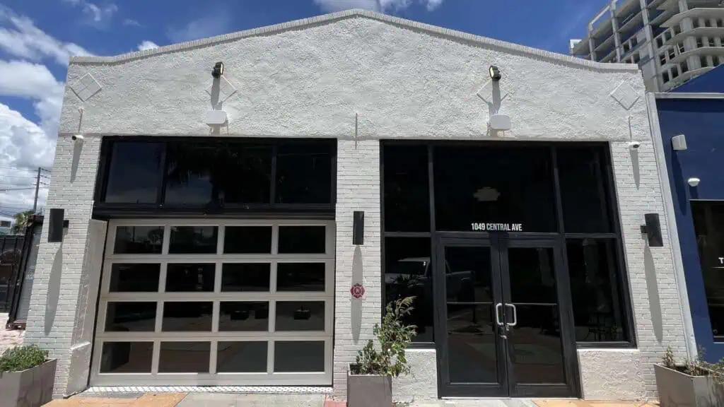 exterior of a bar and restaurant with a large bay door