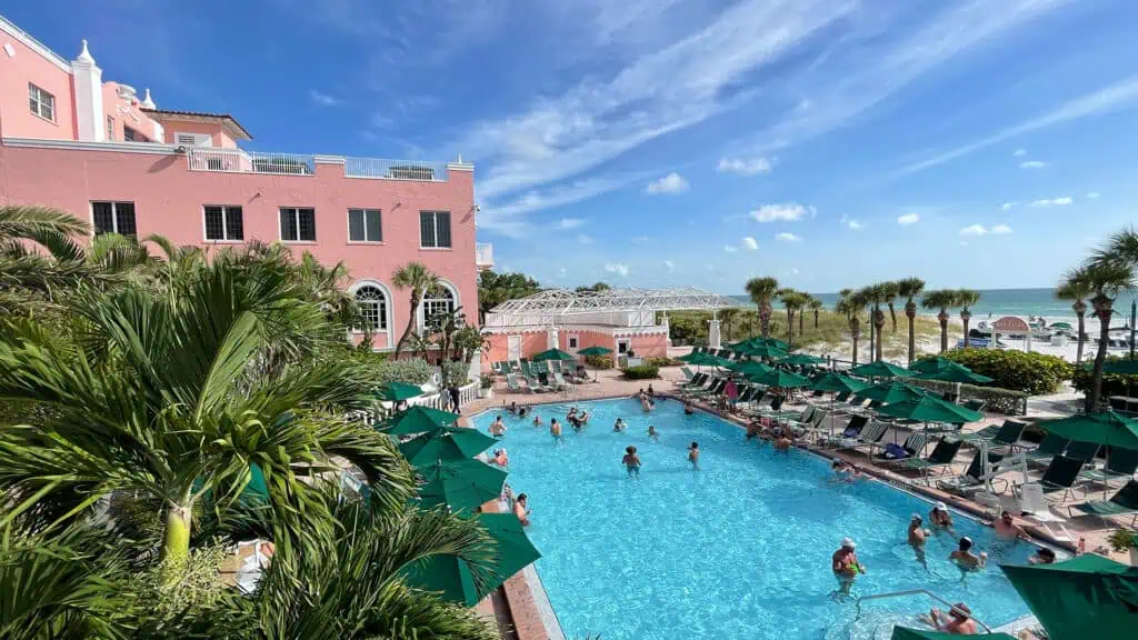 a hotel pool with a beach view 