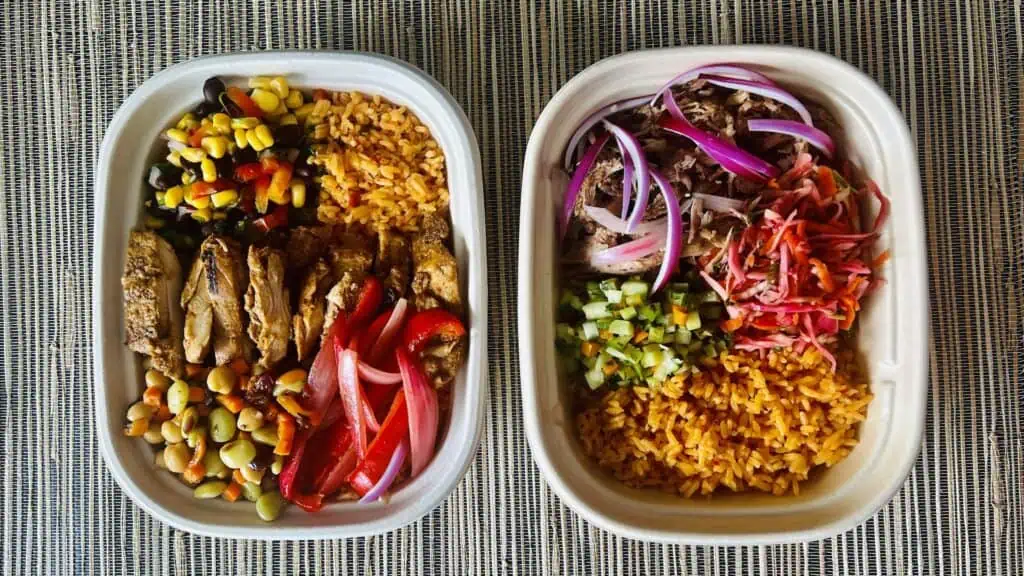 two bowls full of meat and vegetables. 