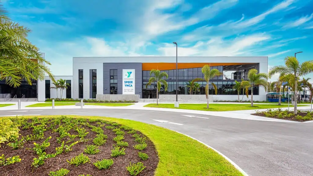 exterior of a middle school with a grass lawn and a winding paved entrance