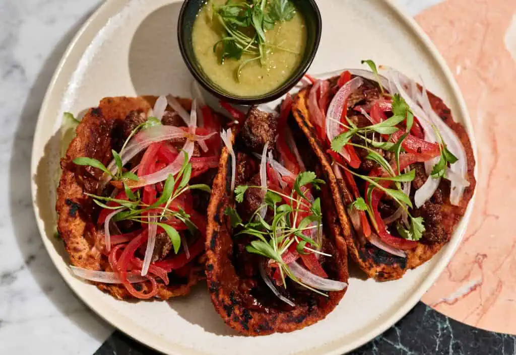 three tacos arranged on a plate