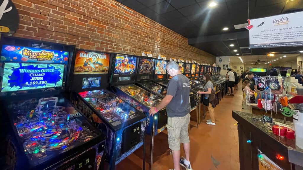 interior of an arcade with pinball machines arranged inside