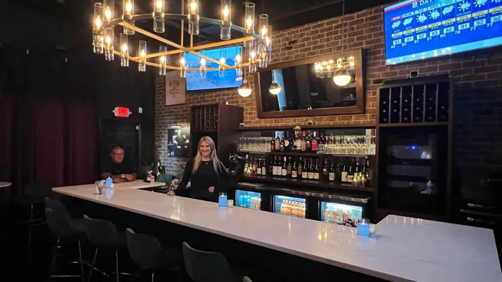 bar with girl posing behind.