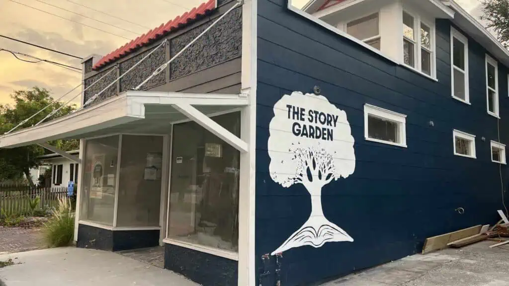 blue building with white tree painted on the side