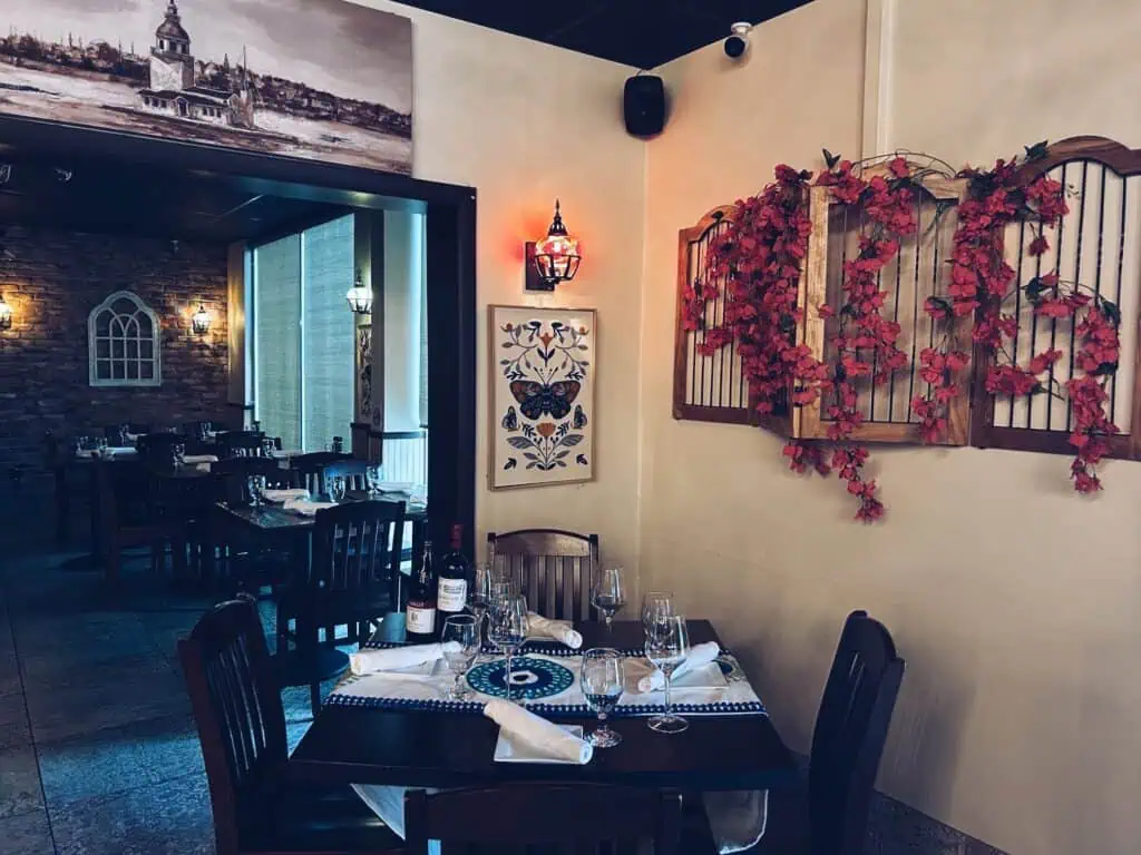 tables covered in wine bottles and plates.