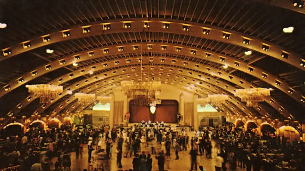 A color photo of a convention in the Coliseum in St. Petersburg, showing the building's wooden trusses.