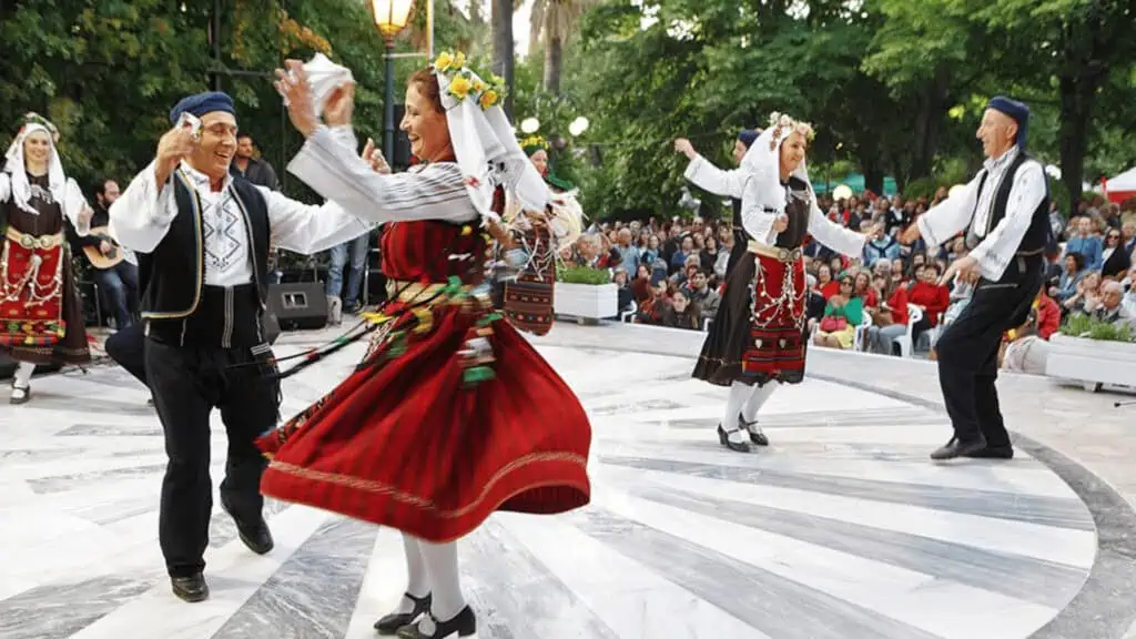 Group of Greek people dancing in street