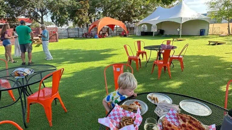 kid eating pizza at cage brewing