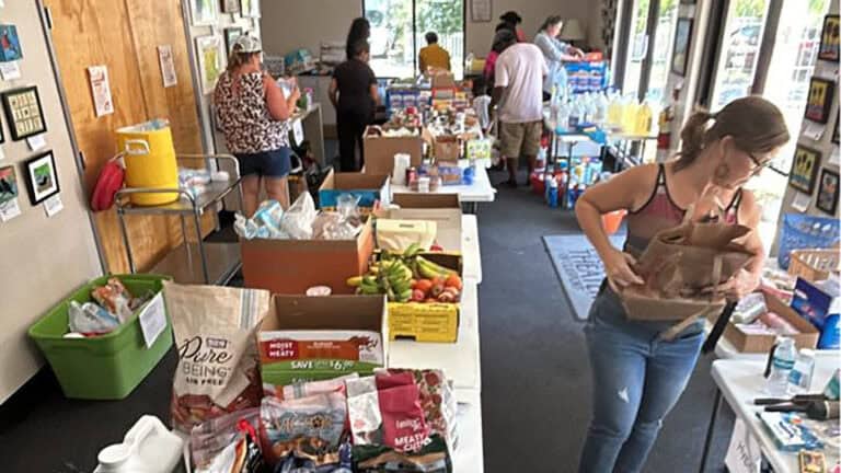 a donation site with rest food and supplies arranged on tables